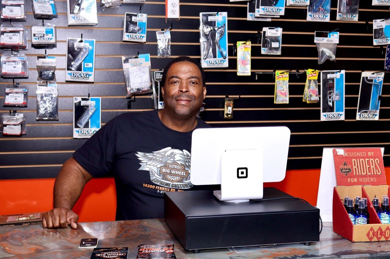 A Detroit Big Wheel Baggers team member behind the shop counter