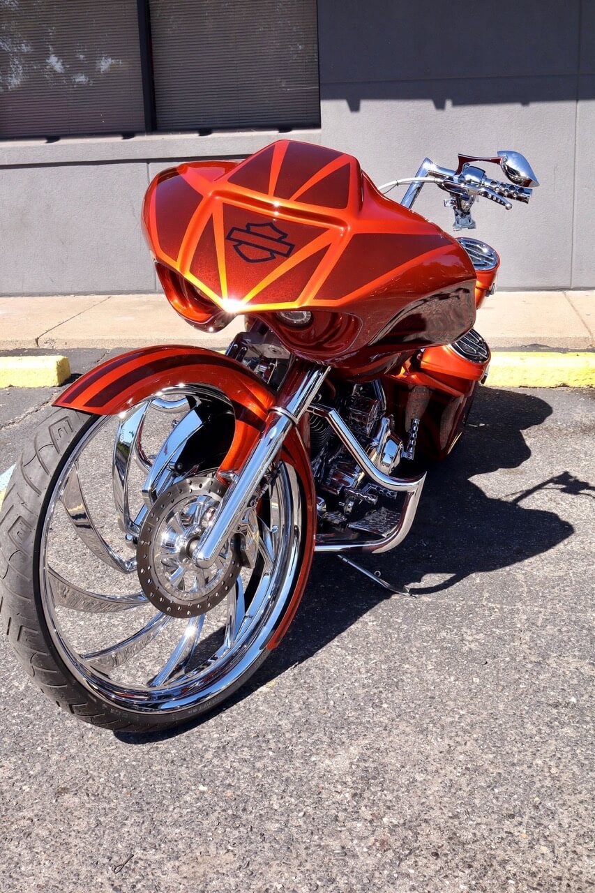 Front view of an orange custom motorcycle